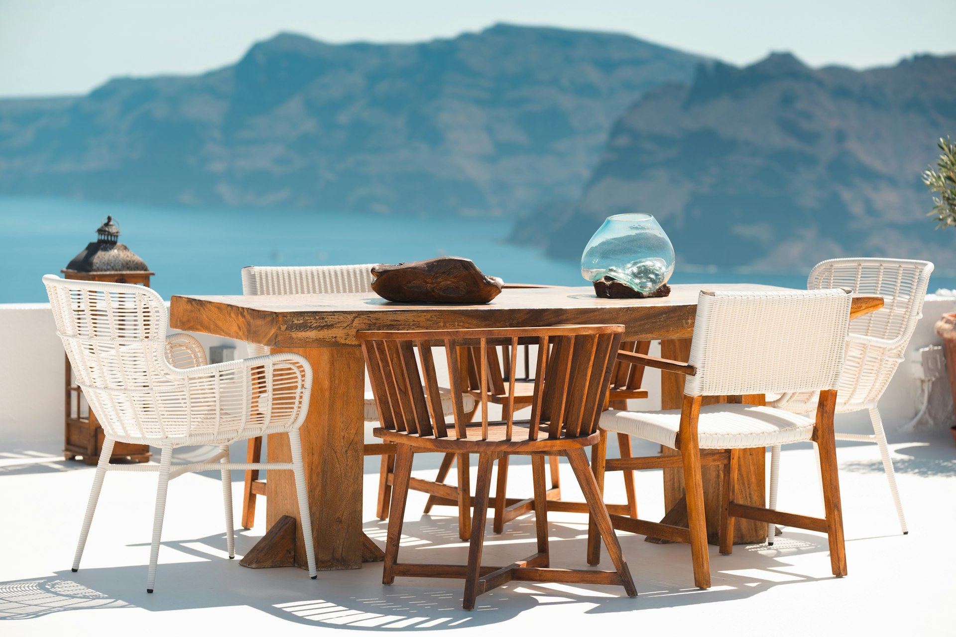 A table with chairs and a vase on top of it