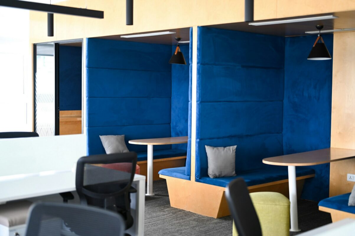 Modern office booths with blue seating and tables