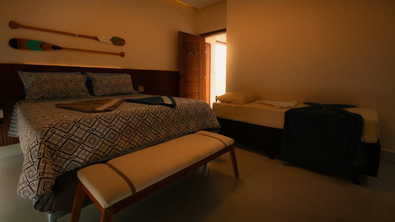 Bedroom with two beds and decorative paddles