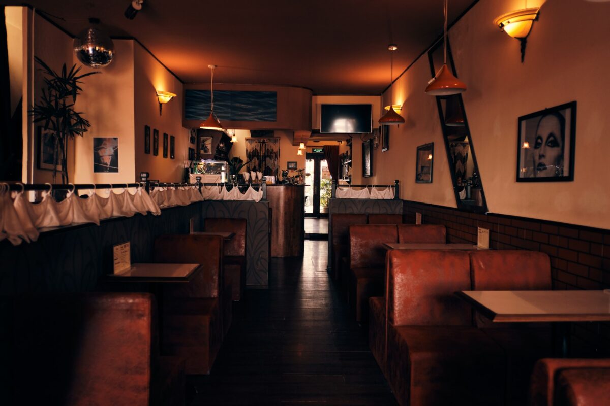 Empty restaurant interior with warm lighting and brown booths