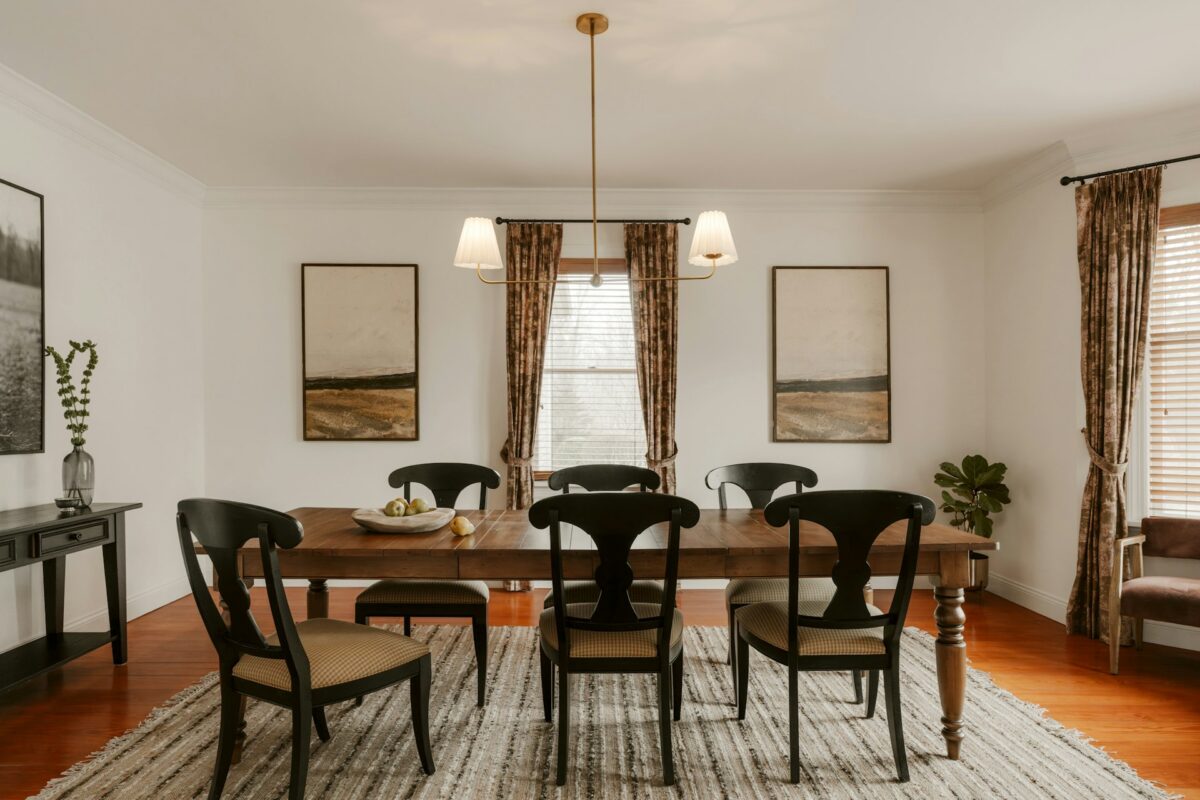 A formal dining room with a wooden table and chairs